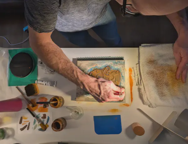 Participant working on a woodblock print