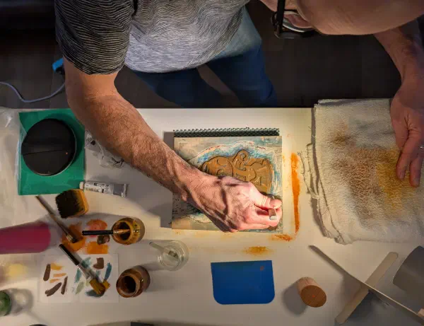 Participant working on a woodblock print